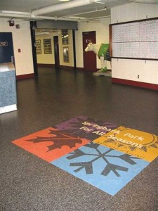 Recycled rubber flooring, including a logo inlay in the lobby, was laid 10 years ago at the Springbank Park for All Seasons in Calgary. It still looks new today.