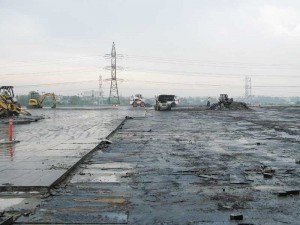 Topping slab removal at a helicopter port to replace an old built-up roof (BUR) waterproofing system.