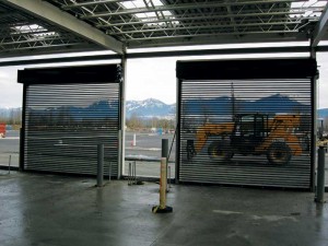 This is a rolling steel door, with each horizontal slat perforated to allow for both visual appeal and ventilation. The slats are powder-coated to suit the area’s décor.