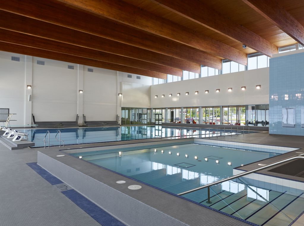 Glulam beams and a cross-laminated timber (CLT) roof deck can be seen above the new pool deck.