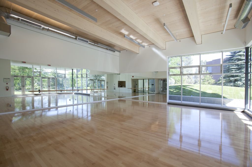 Function meets form: the FWC’s lower-fl oor exercise room reveals the underside of the concrete-wood composite fl oor system above.