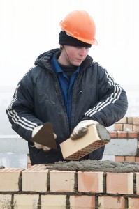 bigstock-A-brick-layer-worker-building--18986885