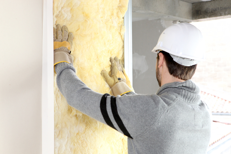 bigstock-Worker-laying-insulation-12641423(2)