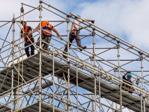 Shown here are construction workers at a scaffolding.