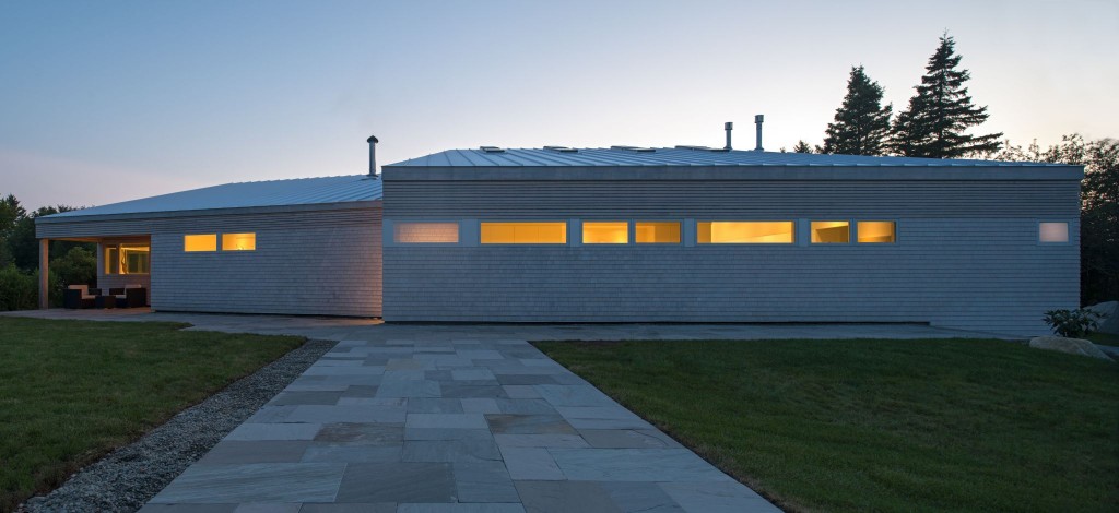 One of Gandhi’s recent projects, Shantih Cottage (Hunts Point, Nova Scotia) features lightly stained eastern white cedar shingles on the exterior, as well as fine horizontal slats, exposed poplar soffits, stainless steel chimneys, and a white aerofoil sun shade. Photo © Greg Richardson Photography 