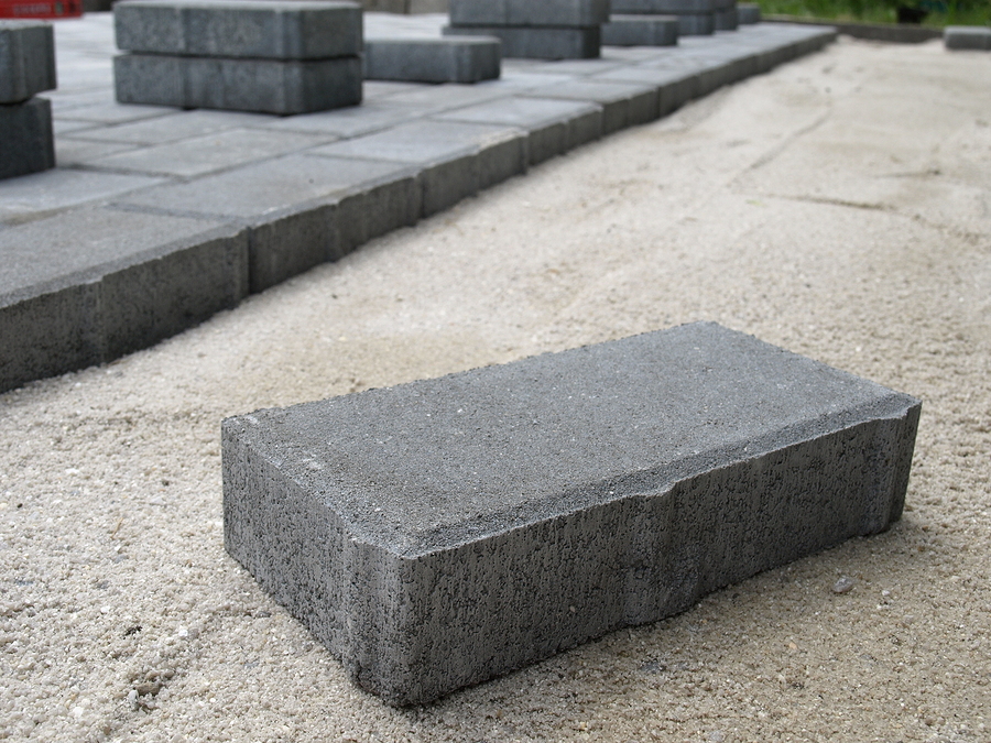 Stones blocks in sand prepared for pavement reconstruction