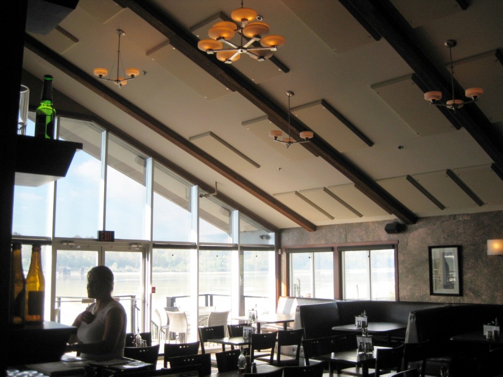 Kingfishers pub in Maple Ridge, B.C. provided a beautiful view for customers, but the glass wall and high vaulted ceiling contributed to long echeos and poor intelligibility. Broadway acoustic panels installed on the ceiling retained the esthetic, but fixed the sound issues. All photos courtesy Primacoustic