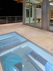 The glass enables visitors to see the salmon hatchery from the deck.