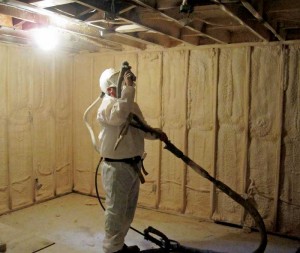 Sprayfoam insulation being applied to a basement. It expands to fill complex shapes in basement headers.