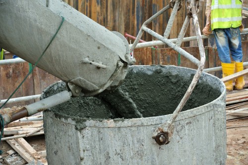 SELANGOR, MALAYSIA - SEPTEMBER 09, 2014: A truck load of concrete is poured concrete into the concrete bucket.