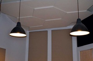 Whether a recording studio or a conference room, honeycomb-shaped acoustic ceiling clouds prevent reflection and control reverb in a space with high ceilings.