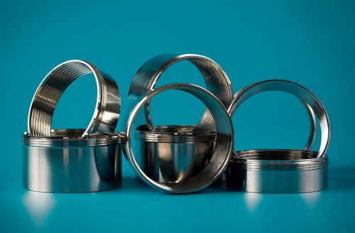 steel chromium-plated rings with thread on a blue background