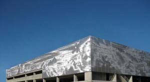 The aluminum panels cladding the Parkade at Southern Alberta Institute of Technology (SAIT) are 100 per cent recyclable and finished in a clear anodize. Using proprietary imaging technology, 3-D images of clouds and sky are sculpted into the metal panels. Software calculates the optimal reflective position for each pixel of an image and punches it into the panel system. Photos courtesy Dri-Design