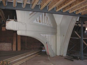 To convert an existing church into multi-family residential units, the authors needed to add the new floors on their own new footings, with new steel beams and new floor joists. From a fire safety perspective, the exposed heavy timber trusses are only allowed to support a roof; any type of floor including a mezzanine would require the existing timbers to be covered up with fire-proofing (such as drywall).