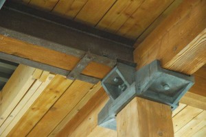 A timber beam with steel channel reinforcing. In this case, any loads carried by the steel reinforcing channels are effectively transferred to the supporting column through direct bearing.