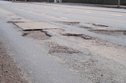 Bad old road big hole in street asphalt