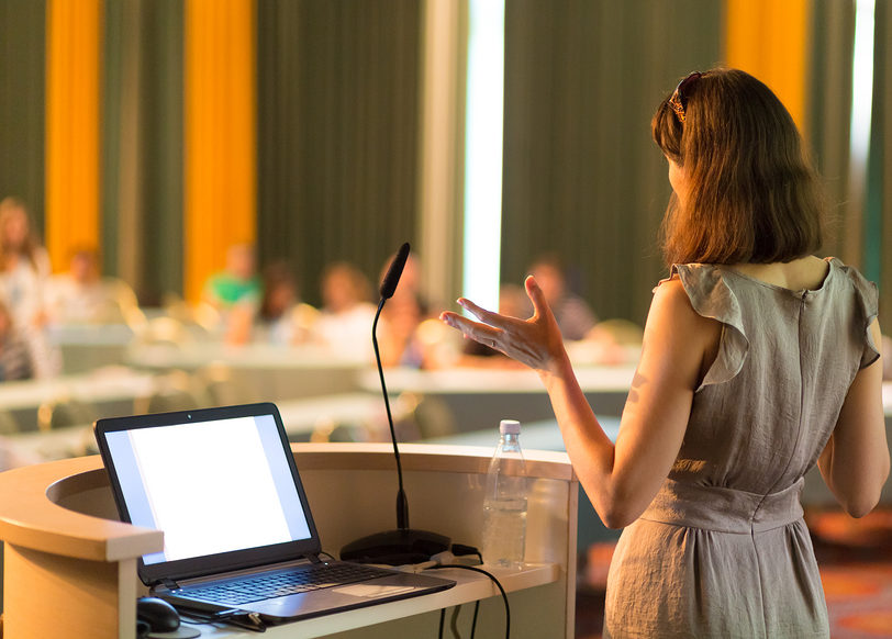 Female speaker at Business Conference and Presentation. Audience at the conference hall. Business and Entrepreneurship. Business woman. Horizontal composition.