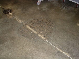 Worn floor where aggregate is exposed.