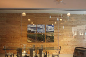 The viewing room at Sandhill Winery in Kelowna, British Columbia, benefits from the acoustic treatment properties of custom printed panels appearing as a hexaptych art display. Photo courtesy Primacoustic