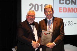 CSC president David Boyle, CTR, presents John G. Cooke, FCSC, RSW, with a CSC Life Award.