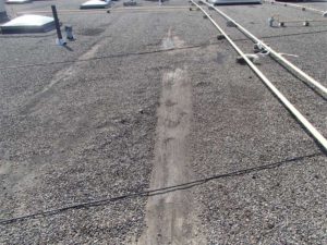 A commercial building in Markham, Ont., with patches over split ridges in a BUR.