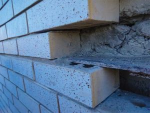 Figure 6: The brick veneer in this photo does not have any provision for movement below the shelf angle. As floor slab deflects, this veneer will be subjected to unintended loads.