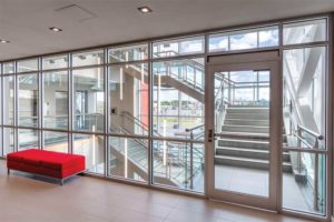 In KMK Place, an office building in St. John’s, large spans of fire-rated glazing separate the main structure from a glass atrium, preserving daylight and views for occupants inside. Photos courtesy TGP