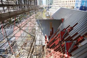 The entire building was completely enclosed in a massive scaffold and covered with a giant tarpaulin to protect it from the weather as the existing roof was removed. Photo © Martin Knowles