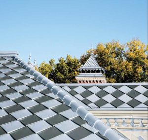 Combining interlocking roof tiles of zinc ASTM B69-16, Standard Specification for Rolled Zinc, Type 2 alloys in pre-patinaed blue-grey and graphite-interlocking roof tiles can create a checkerboard esthetic.