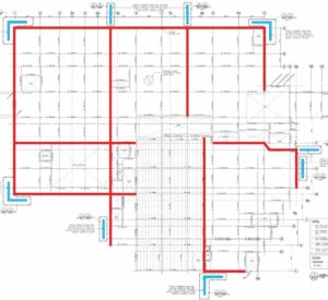 The outline of the building footprint with layout of external precast shear walls (blue) and internal steel drag struts (red).