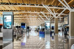 The acoustic ceiling design of the international terminal at the YYC Calgary International Airport features variety of ceiling surfaces such as modular, perforated aluminum panels, and lightweight wood, all of which mitigates noise and offers a look that is distinctly ‘Calgary.’ Photos © Jeffrey Totaro