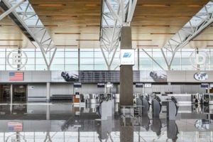 The wood ceiling above the ticketing area at the international terminal at the Calgary airport is a high-performance acoustic surface with a warm esthetic.