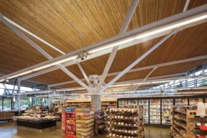 View of the tubular steel tree column in Askew's Uptown Supermarket. Photo © Derek Lepper Photography. Photo courtesy Allen+Maurer Architects Ltd.