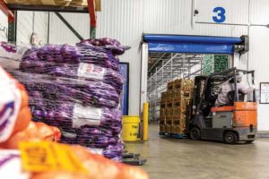 High-speed doors, like this one at Maglio Companies, a produce processing facility in Milwaukee, WI, minimize collisions with forklifts.