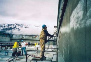 A protective layer of crystalline waterproofing is applied to the Valdez Marine Terminal water purifying tanks in Prince William Sound, Alaska.