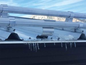 Bar or fence- styled snow guards can be attached to standing-seam roofs with clamps or attached to exposed, fastened roofs via screws.