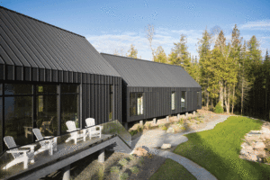 Special high-grade (SHG) zinc in a dark-grey matte finish was chosen for sustainability and low-maintenance in this private retreat on Lake Huron, Ontario.