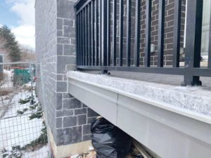 Figure 19 Metal clamp at leading edge of waterproofing. Concealed: Drip flashing fastened to rim board, not field of balcony.