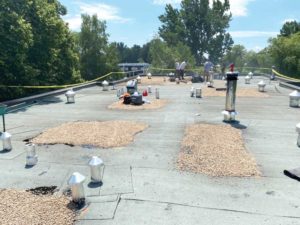 Modified bitumen roof drainage improved with an asphalt and gravel application.