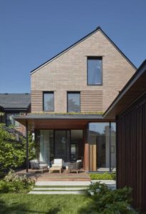 Front facade during daytime of award-winning Jackman House, which uses brick masterfully.