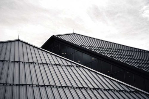 A black and white photo of two roofs.