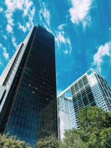 Two skyscrapers against a clear sky.