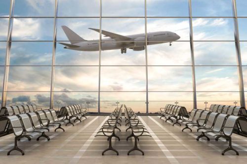 airplane taking off at an airport terminal