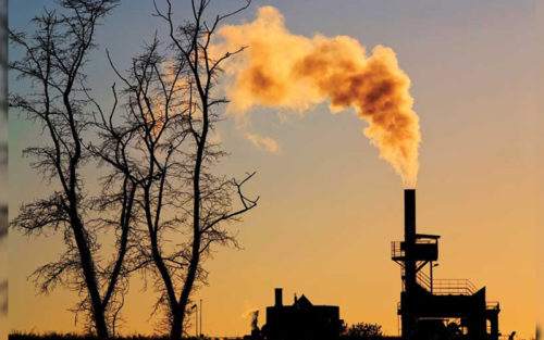 silhouette of power plant with smoke