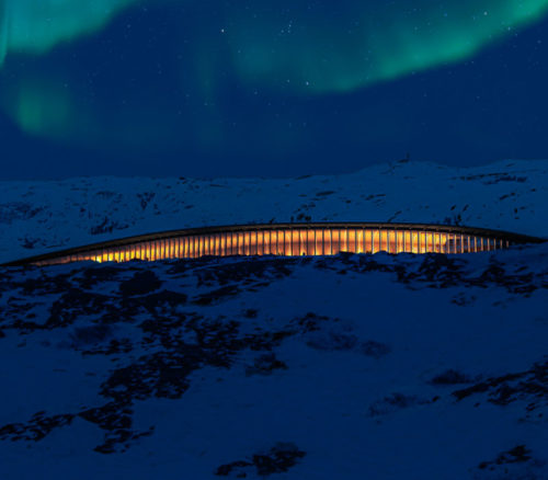 heritage centre at night with the northern lights in the sky