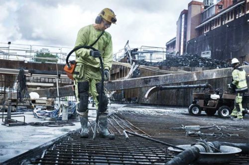 construction worker in neon green doing consolidation work