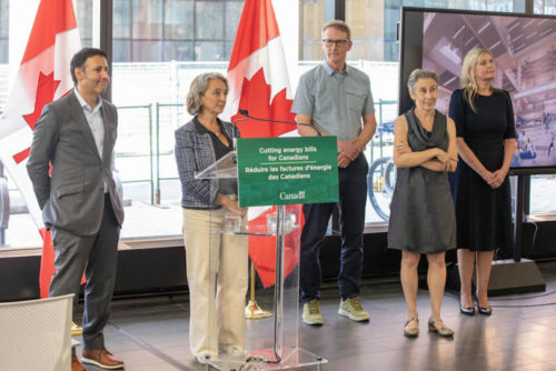 group of people standing in front of Canadian flag