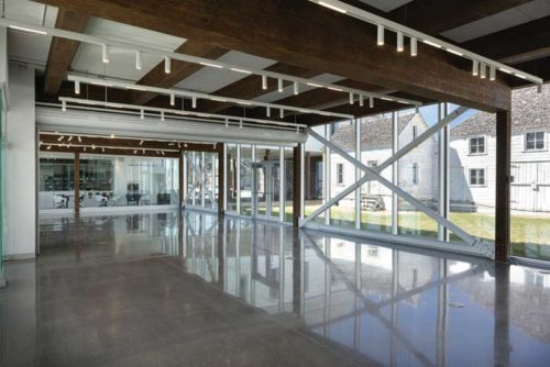 empty interior of a multifunctional room with glass facade and wooden ceiling 