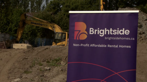 Purple banner with a construction truck behind it