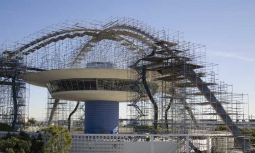 building under construction with cables and metal rods all over